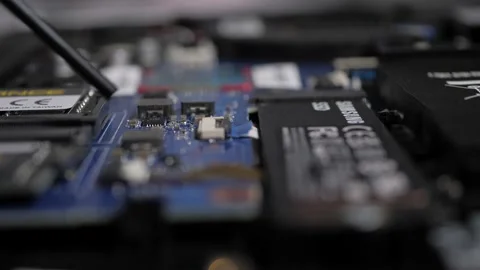 Blowing Out Computer Components - Macro Stock Footage 220736747
