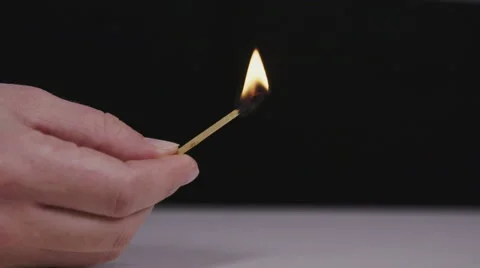 Blowing out a lighting match, black background Stock Footage 58761305