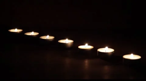 Blowing out a line of tea candles Stock Footage 42794680