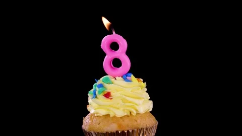 Blowing Out Number Eight Candle on Birthday Cupcake Stock Footage 314928909