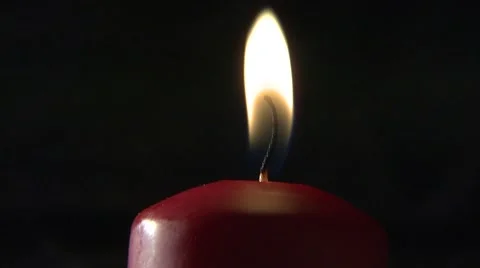 Blowing out a red candle Stock Footage 6469602
