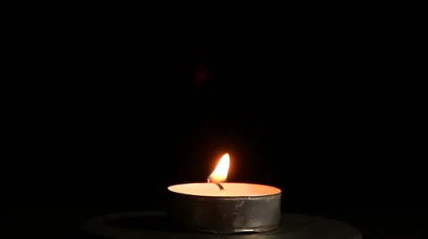 Blowing out a rotating candle Stock Footage 32659486