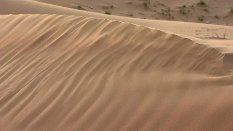 Blowing Sand Dunes across the ridge in the arid desert Stock Footage 120697381