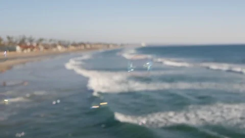 Blowing soap bubbles on ocean pier in California, blurred summertime background Stock Footage 129782347