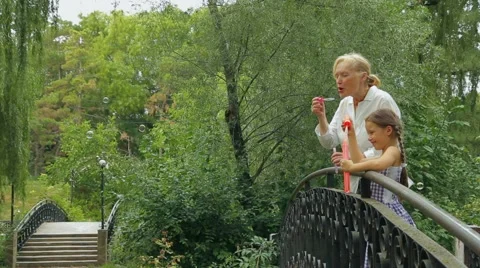 Blowing Soap Bubbles In A Park Stock Footage 52757048