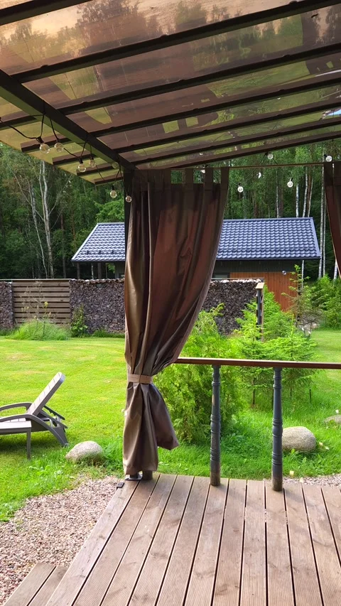 Blowing soap bubbles while standing on terrace of log cabin Stock Footage 339134902