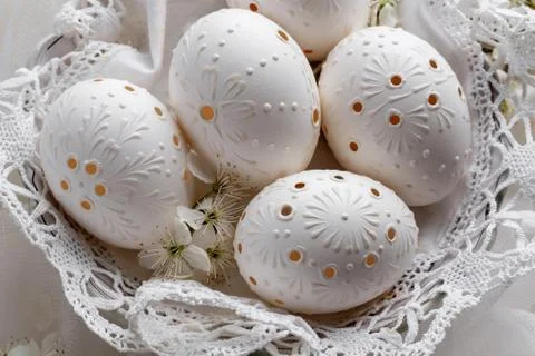 Blown out white Easter eggs decorated with wax Stock Photos