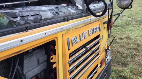 Blown up school bus - burnt out automobile - looks like war zone Stockbeeldmateriaal 58653261