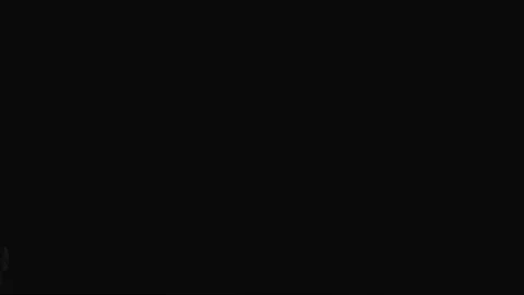 Blows smoke rings on a black background Stock Footage 127931092