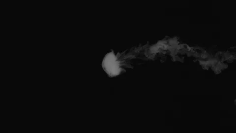 Blows smoke rings on a black background Stock Footage 127931350