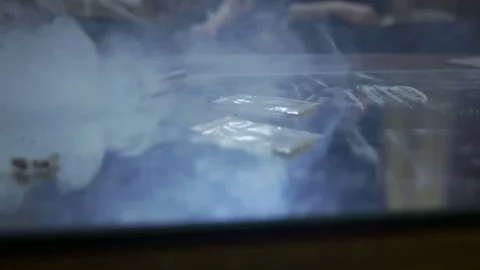 Blows of smoke on table with cocaine bags, powder Stock Footage