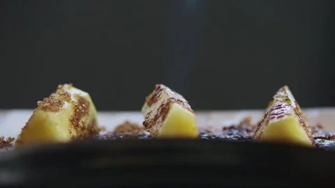 Blowtorch flame heating brown sugar on pineapple slices Stock Footage 274709856