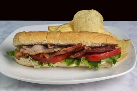 Blt sub  served with potato chips Stock Photos