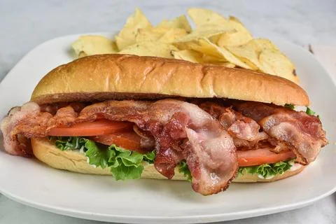 Blt sub served with  potato chips Stock Photos