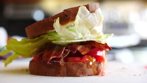 BLT toast falling slow motion on top of the sandwich bacon lettuce tomato Stock Footage 206574440