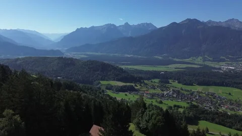 Bludenz, Austria - 08/11/2024: Drone follow Paraglider which fly through Video stock 282429190
