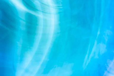 Blue abstract background with gently blurred chaotic white lines waves. Stock Photos