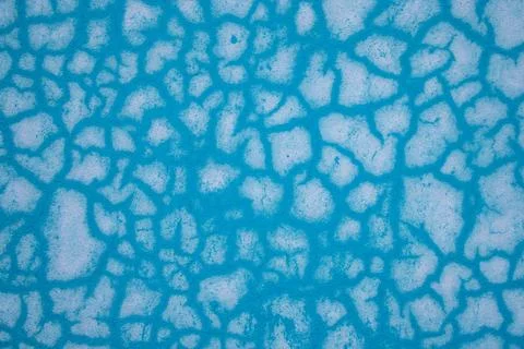 Blue abstract pattern texture background with cracks and holes. Close up. Stock Photos