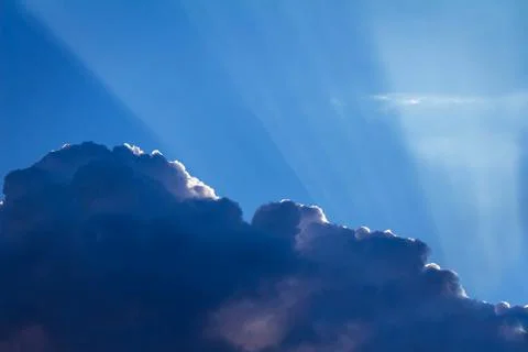 Blue abstract sunset clouds with rays. Stock Photos