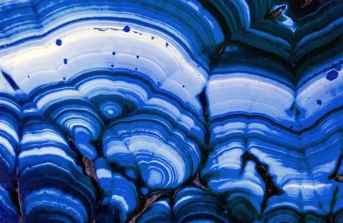 Blue agate stone with layered patterns and textures displayed on a surface Stock-Fotos