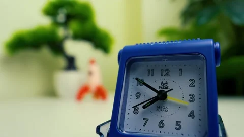 Blue Alarm Clock with Blurred Background, Blue alarm clock with blurred pla.. Stock Footage 318578070
