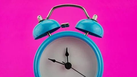 Blue alarm clock on pink background Before Twelve o'Clock on New Years Eve .. Stock Photos