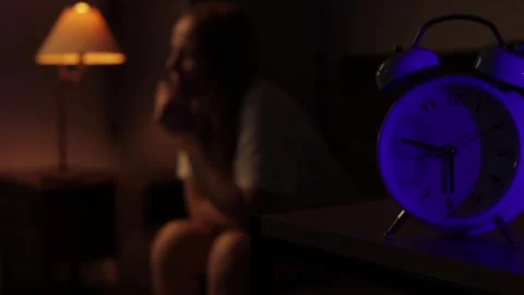 Blue Alarm Clock Show 6:45 a.m. Sits on Nightstand in Dimly Lit Bedroom. Wo.. Stock Footage 288091196