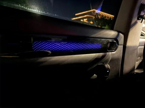 Blue ambient light in a car interior at night. Stock-Fotos