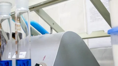 A blue ampule machine is working in a science lab. two pulses in the foreground Stock Footage 130896269