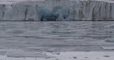 Blue Ancient Glacial Ice in Cliff at Shoreline Stock Footage 56739807