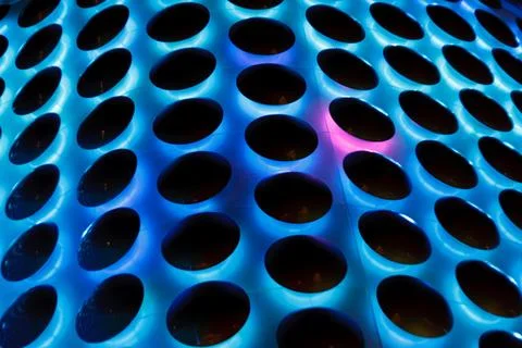 A blue and black pattern of circles with a pink dot in the middle Stock Photos