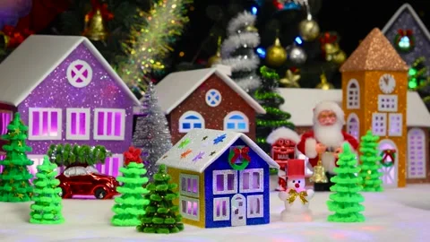 Blue and brown house surrounded by snowman and fir trees Stock Footage 292923731