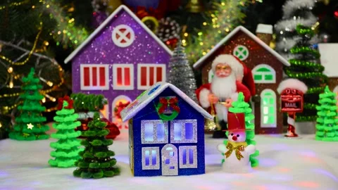 Blue and brown house surrounded by a snowman and Christmas trees Stock Footage 294683090