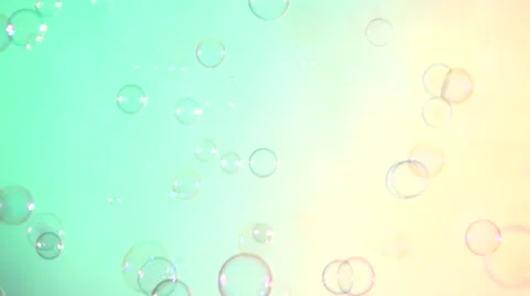 Blue and clear soap bubbles on turquoise and light pink, background Stock Footage 53020123