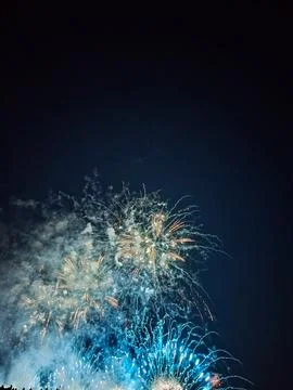 Blue and gold fireworks exploding in night sky at Cannes 库存照片