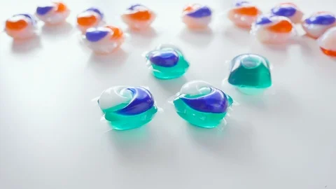 Blue and Green Laundry Detergent Tide Pods Bounce in Slow Motion Stock Footage 85991427