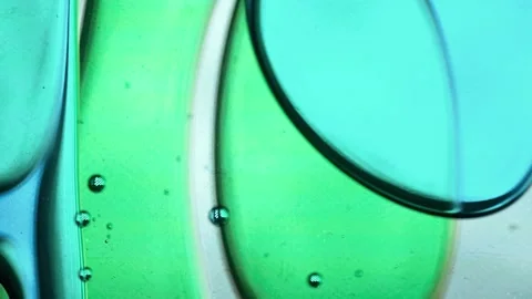 Blue and green liquid bubbles moving slowly inside a vertical lava lamp. The Stock Footage 314659379