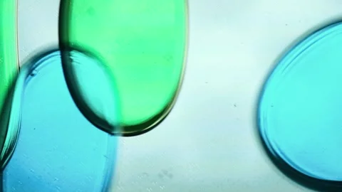 Blue and green liquid bubbles moving slowly inside a vertical lava lamp. The Stock Footage 314659473