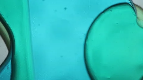 Blue and green liquid bubbles moving slowly inside a vertical lava lamp. The Stock Footage 314659723