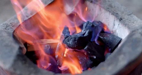 Blue and orange flames.Empty hot charcoal grill with a bright flame. Stock Footage 252285976