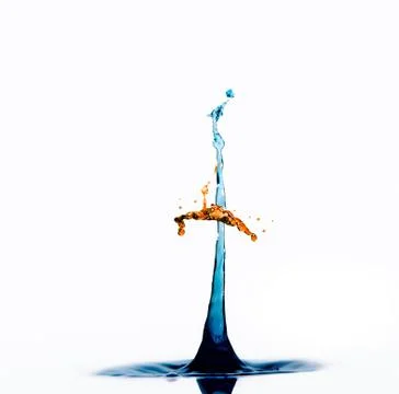 Blue and orange water drops create umbrella on column abstract Stock Photos
