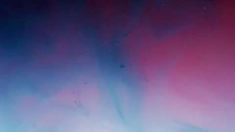 Blue and pink ink dissolving in water Stock Footage 100023573