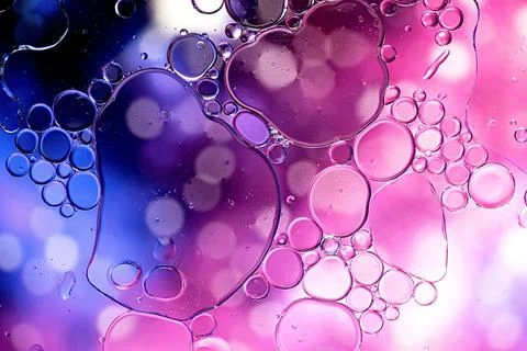 Blue and purple abstract pattern made with oil bubbles on water Stock Photos