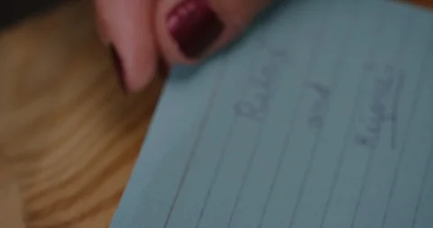 A blue and purple note that says "Relax and Rejoice" is folded in half. Stock Footage 101257667