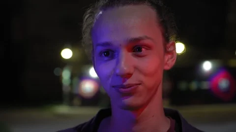Blue and red light on young men's face outdoors at night 3 Stock Footage 95861476