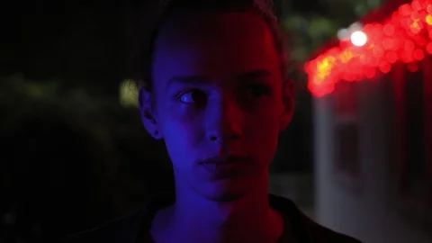 Blue and red light on young men's face outdoors at night 1 動画素材 95862064