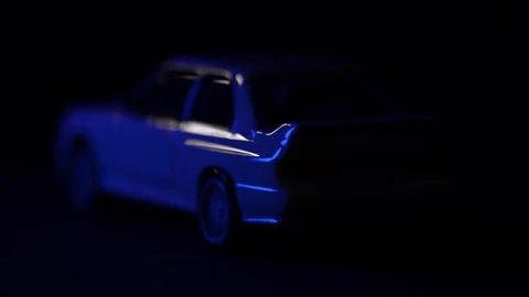 Blue and red lights over a white BMW M3 E30 car Stock Footage 289555017