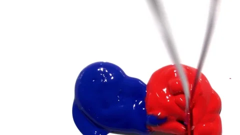 Blue and Red poster paint spilling and mixing together on white background Stock Footage 72287023