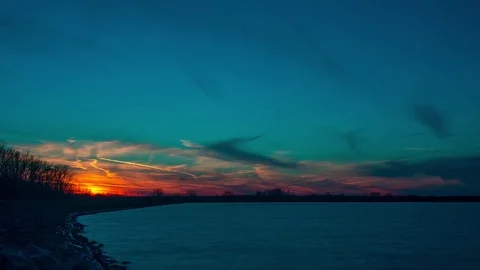 Blue and Red Sunset Over Calm Reservoir Stock Footage 81688933