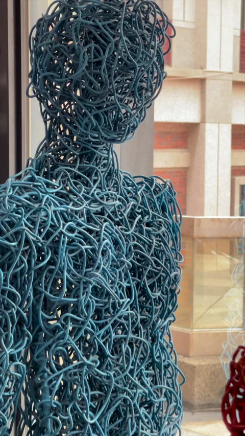 Blue And Red Wire Figure Sculptures Displayed By A Bright Window Stock Footage 344235244